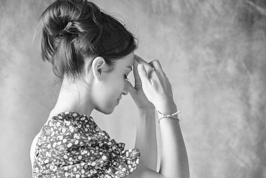 Portrait artistique en noir et blanc d'une jeune fille. Plan poitrine. attitude songeuse. Réalisé en studio à Tarbes.