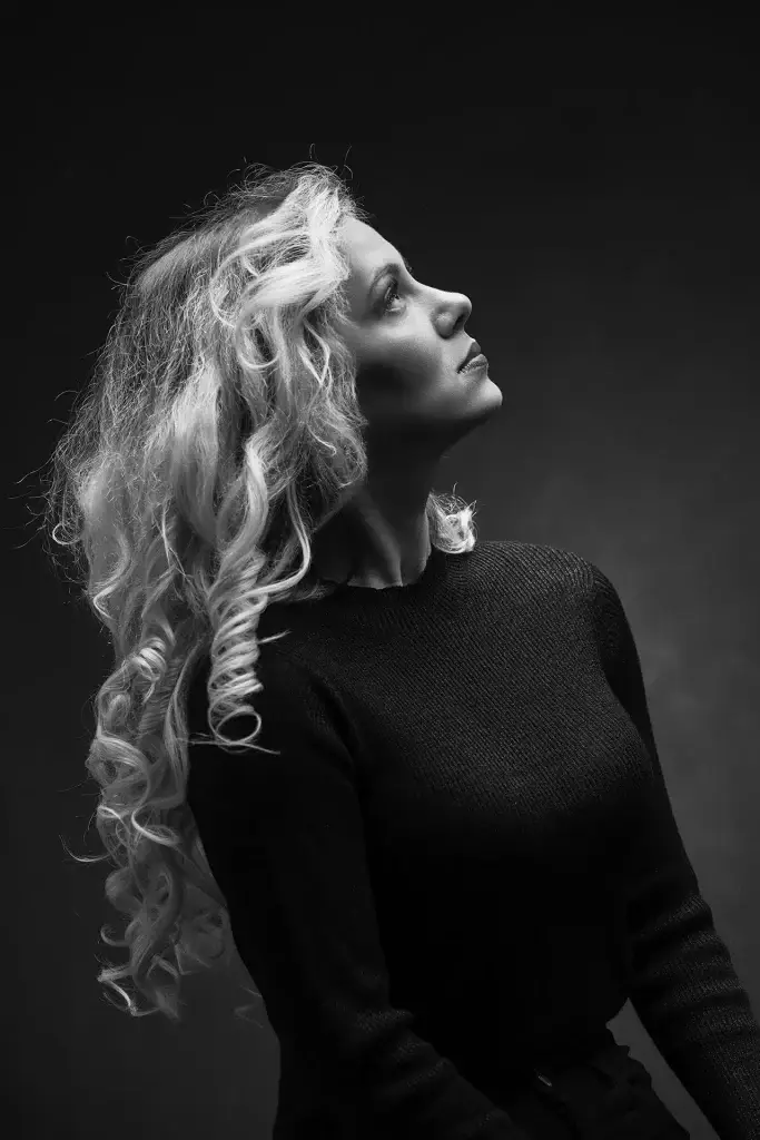Portrait beauté intense d'une jeune femme blonde. Lumière douce en clair obscur.