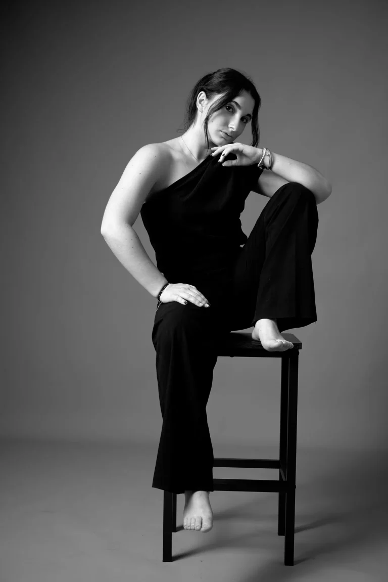 Book modèle en noir et blanc, pose assise sur un tabouret